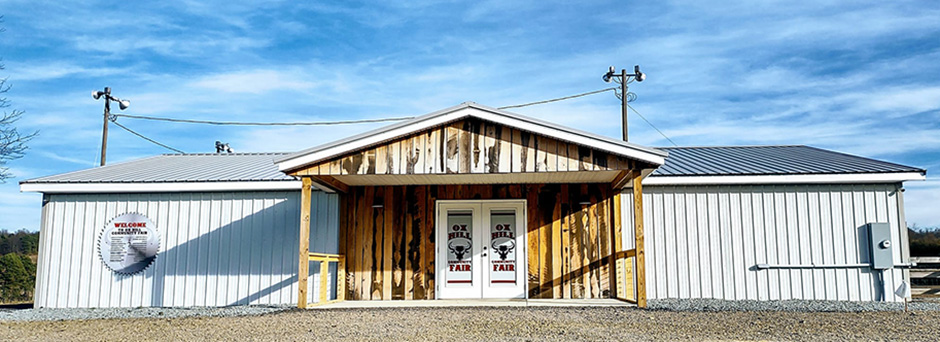 The Ox Hill Community Fair building with a blue sky in the background