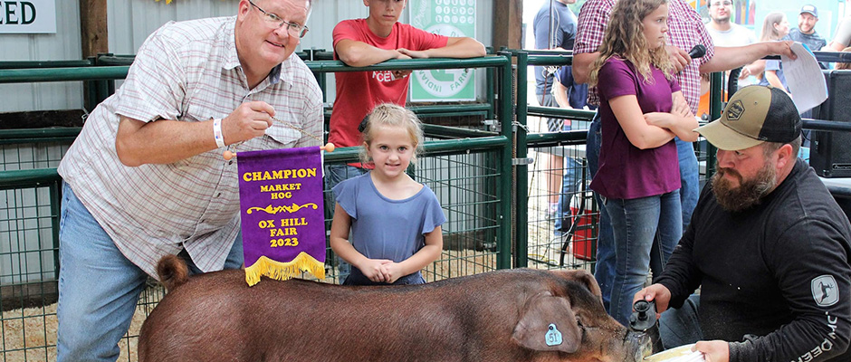 a young girl with her winning market pig