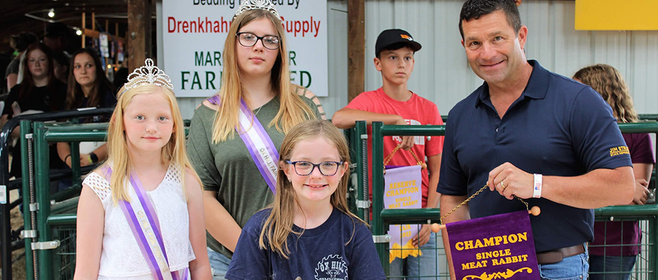 a young girl who won champion in single meat rabbit