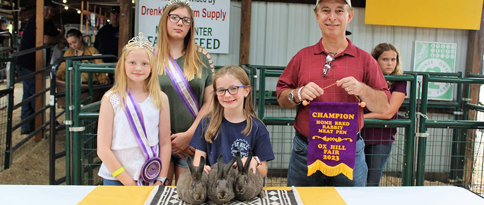 a young girl with her winning market rabbits
